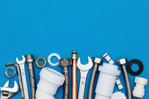 Various pieces of plumbing hardware against a blue background in El Paso.